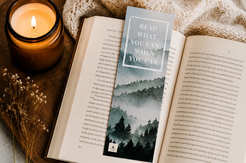 Read what you can when you can bookmark resting in an open book beside a candle
